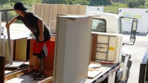 Jim Nickelson, manager, Operations & Logistics for Operation Troop Appreciation, arranging items on a MyWay Mobile Storage truck during OTA’s move.